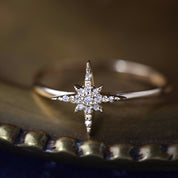 14k gold starburst diamond ring with hand-set pave diamonds on a delicate straight band in size 7.
