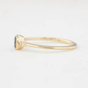 Side view bezel set oval Madagascar sapphire ring with two natural diamond accents in a low profile 14k gold setting.