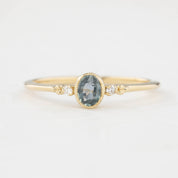 Bezel set oval Madagascar sapphire ring with two natural diamond accents in a low profile 14k gold setting.