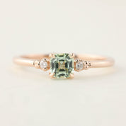 Rose gold ring with 0.5ct radiant cut mint tourmaline and two small diamonds on a delicate band