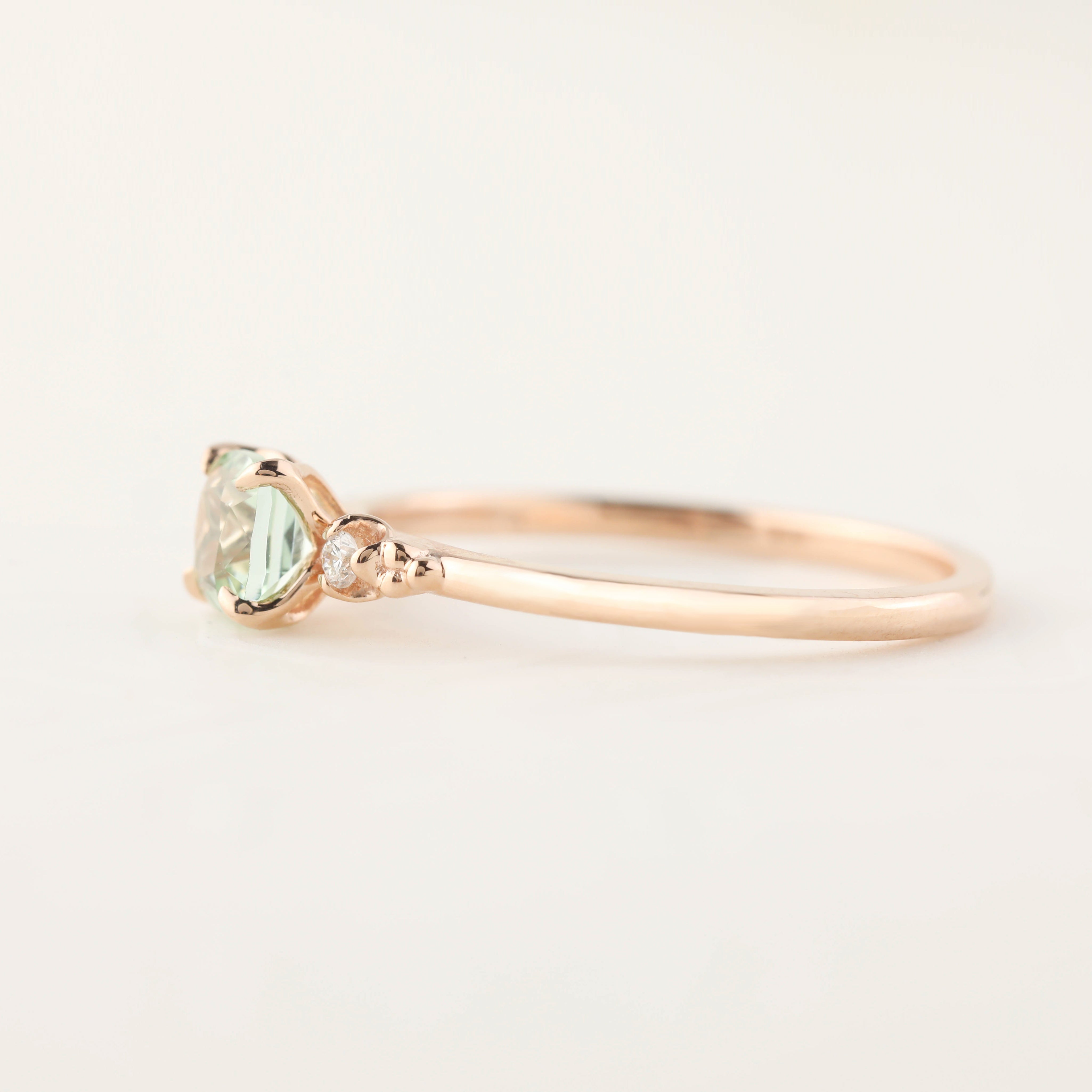 Side view of Estel Ring with 0.5ct radiant cut mint tourmaline and small diamonds in 14k rose gold band
