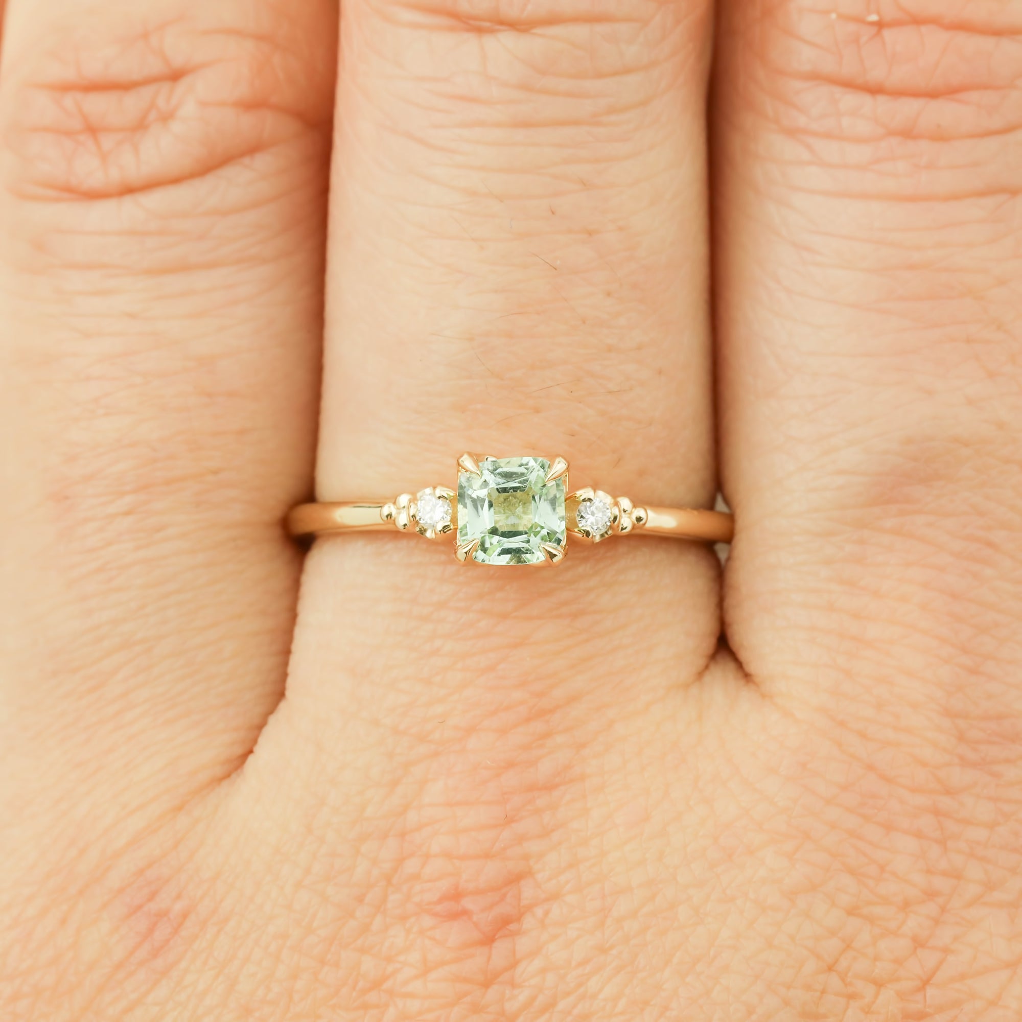 14k yellow gold ring with 0.5ct radiant cut mint tourmaline and diamond accents on finger size 7