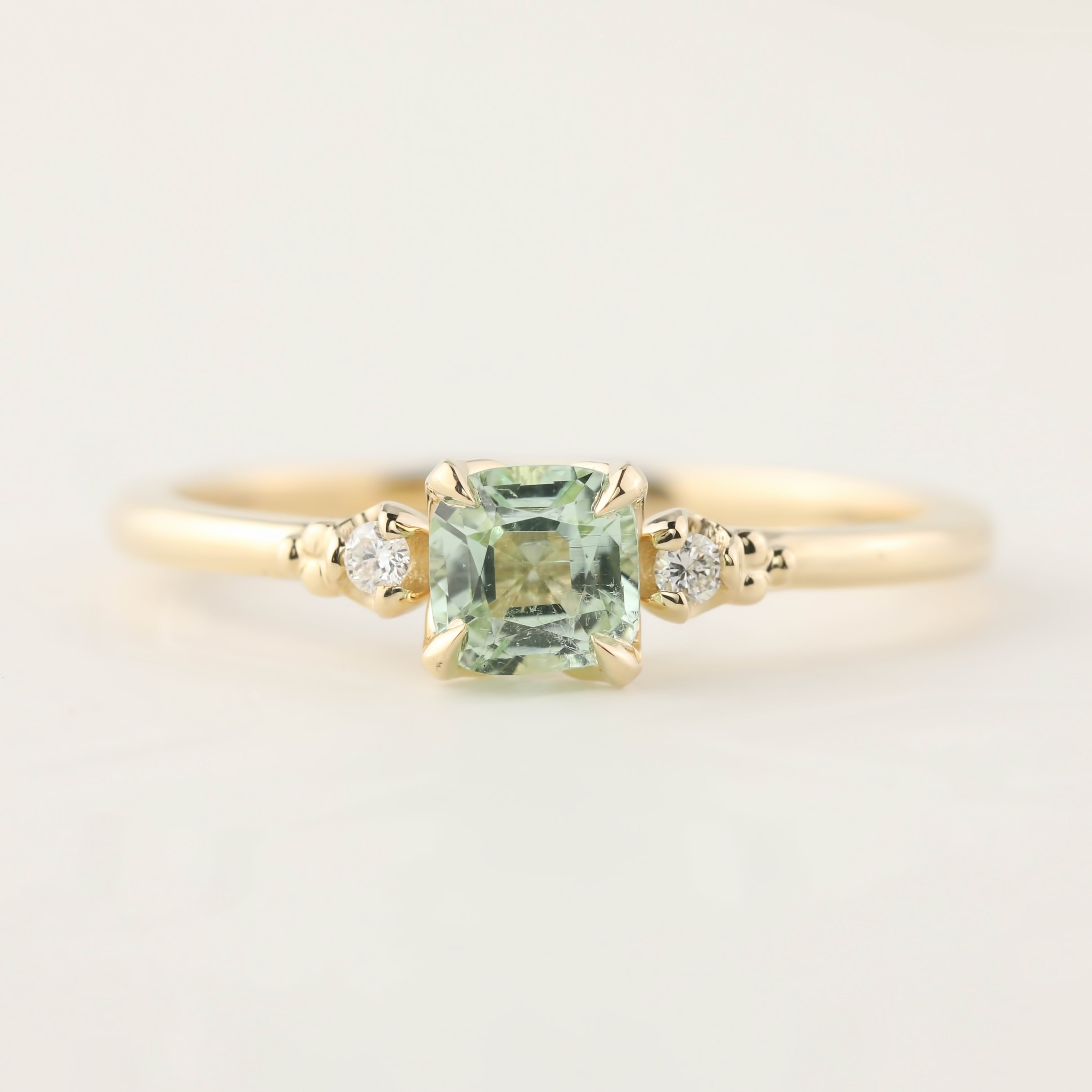 14k yellow gold ring with 0.5ct radiant cut mint tourmaline and two small brilliant cut diamonds