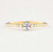 Estel Ring featuring a 0.20ct light blue unheated oval sapphire and 14k yellow gold diamond accents