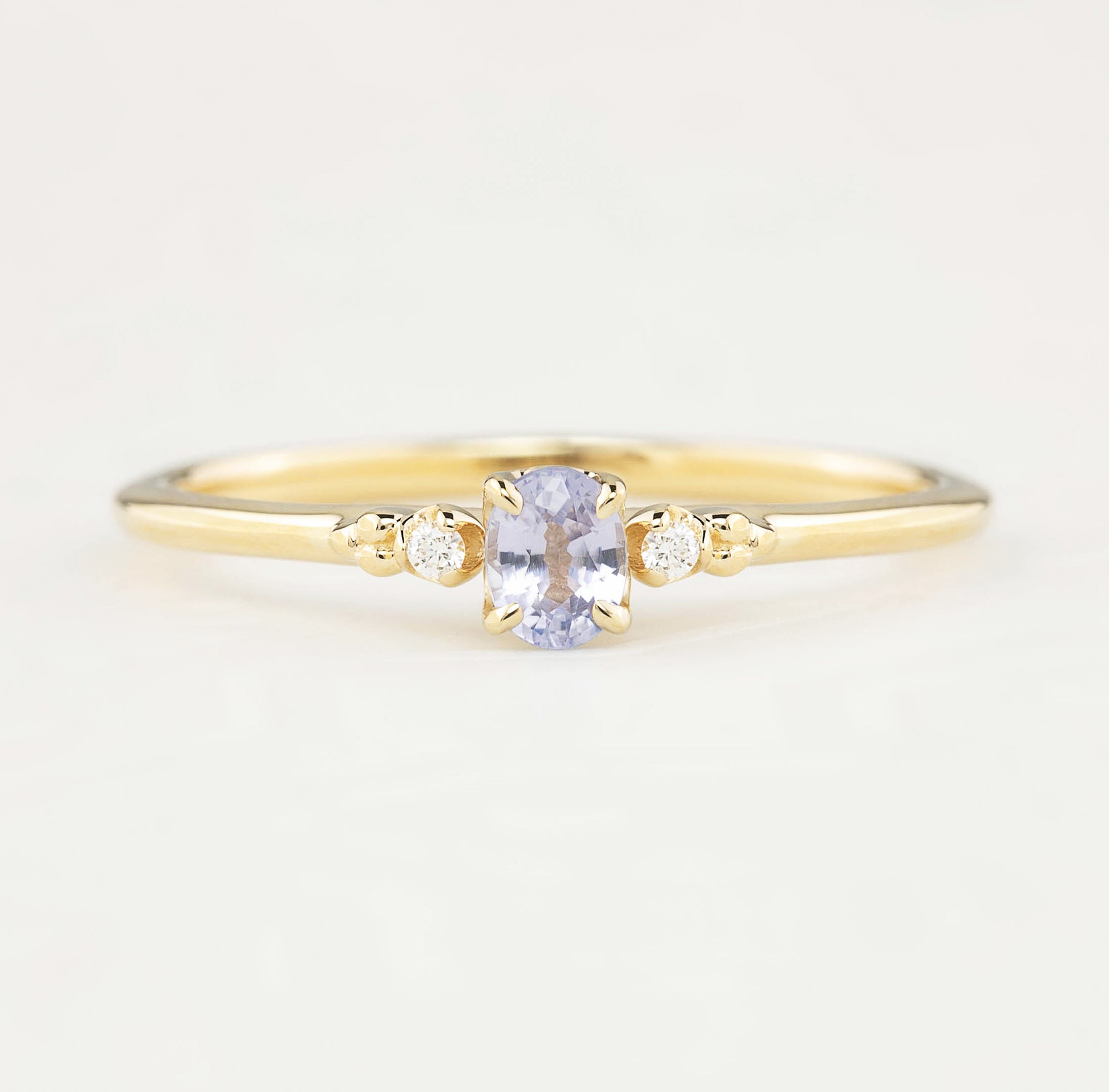 Estel Ring featuring a 0.20ct light blue unheated oval sapphire and 14k yellow gold diamond accents