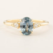 Estel Ring featuring a 1.4ct light blue-green Montana Sapphire with white diamond accents in 14k recycled gold