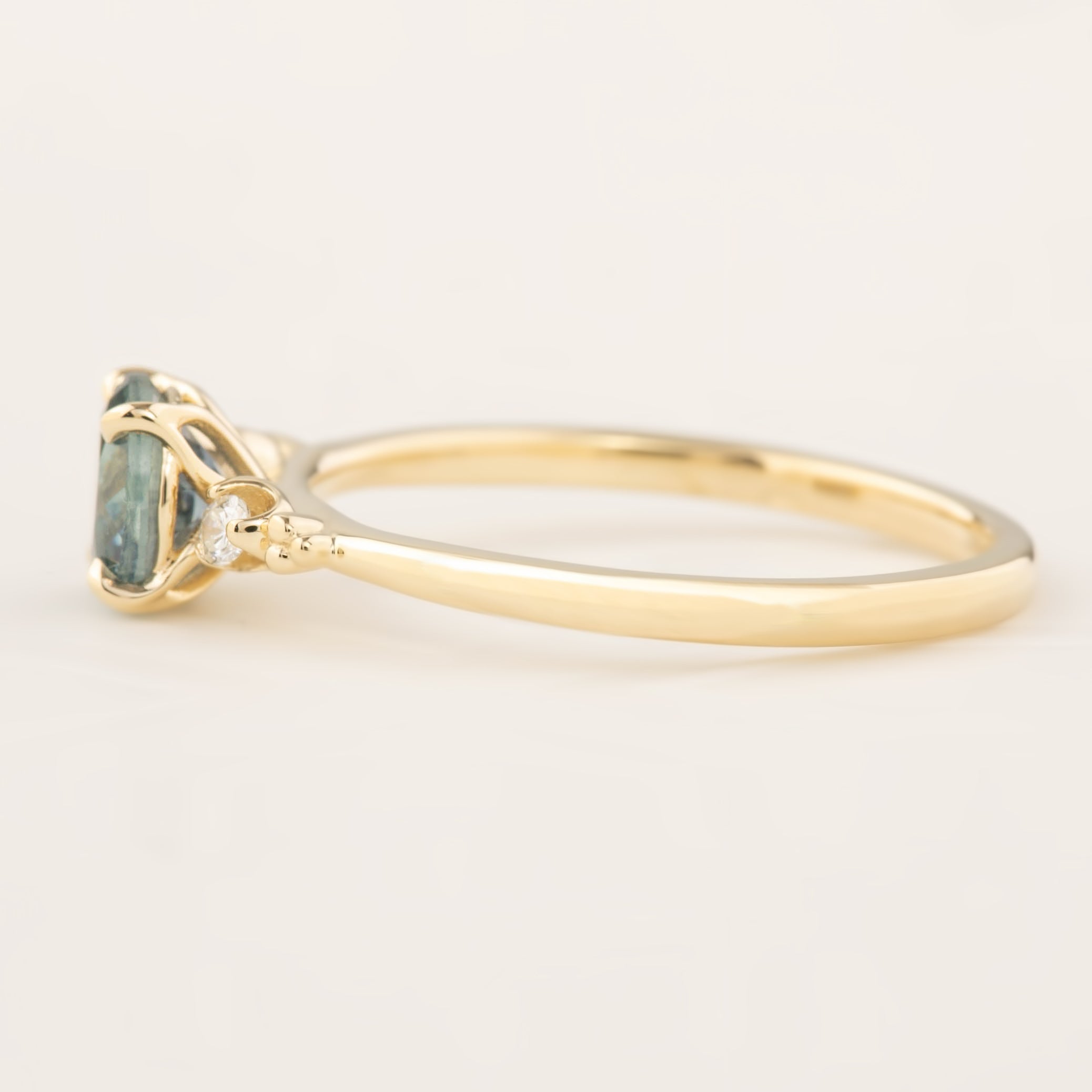 Estel Ring featuring 1.04ct blue green Montana sapphire, handmade with recycled 14k gold and white diamond accents
