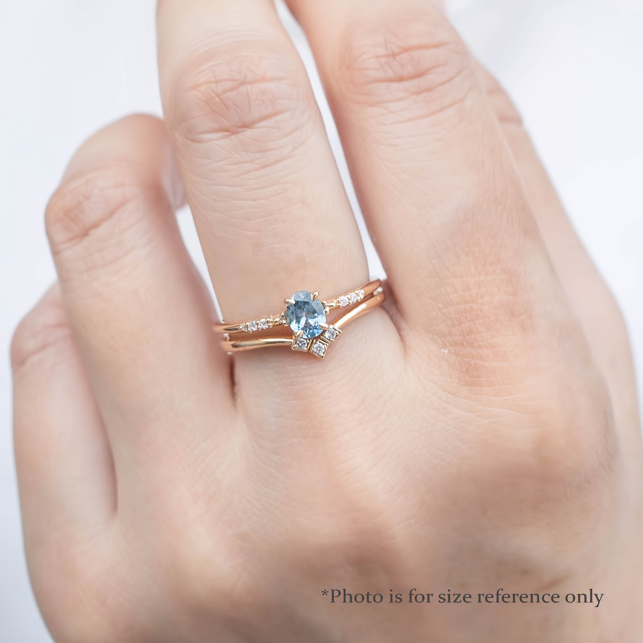 Model wearing the Eloise sapphire ring to show the brilliance of the pave diamonds and the scale of the 0.45ct oval stone.