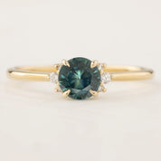 Lena Ring with 0.65ct teal blue Montana Sapphire, white accent diamonds, 14k yellow gold, handmade and ethically sourced