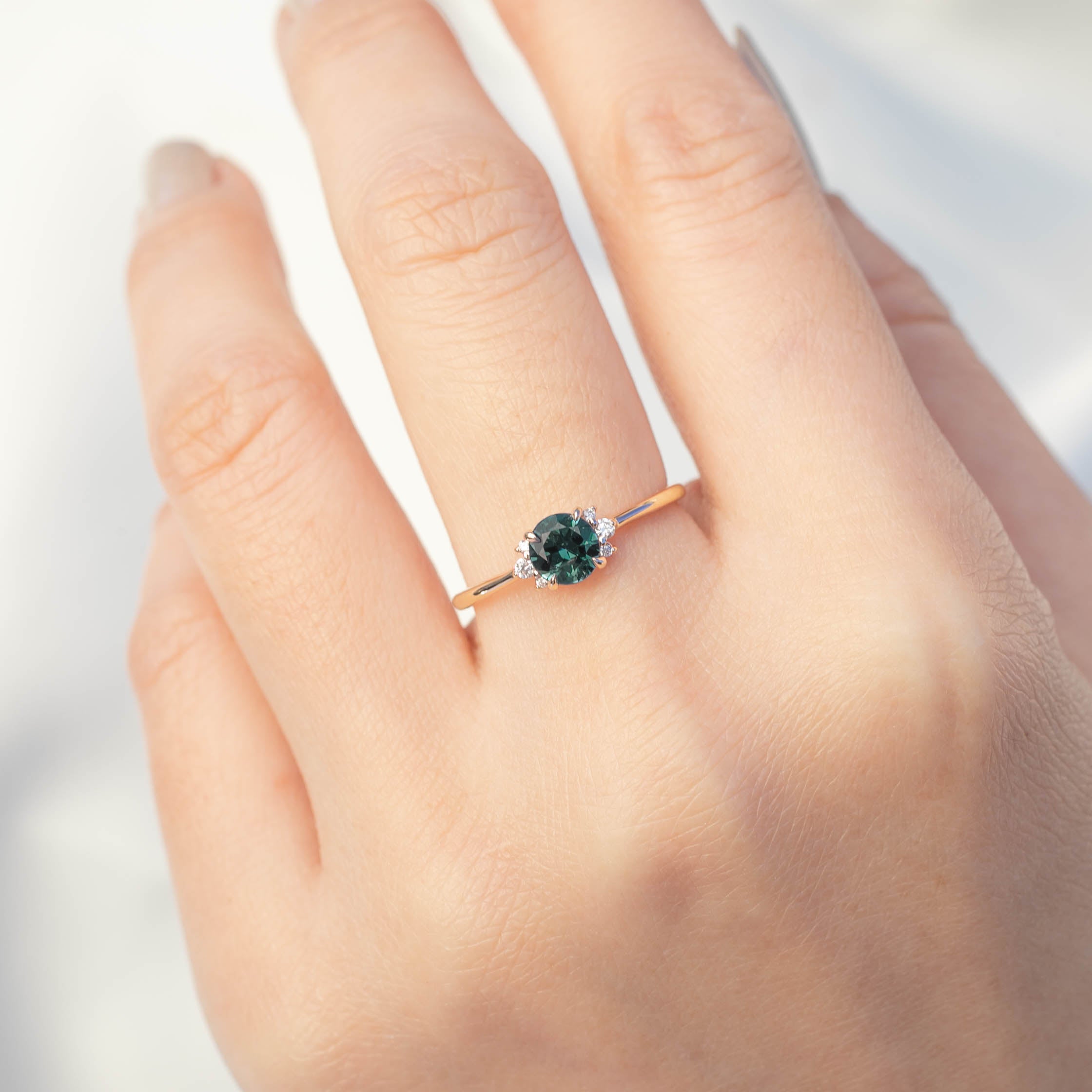 Lena Ring with 0.65ct teal blue Montana sapphire, white diamonds, handmade 14k yellow gold, one of a kind design.