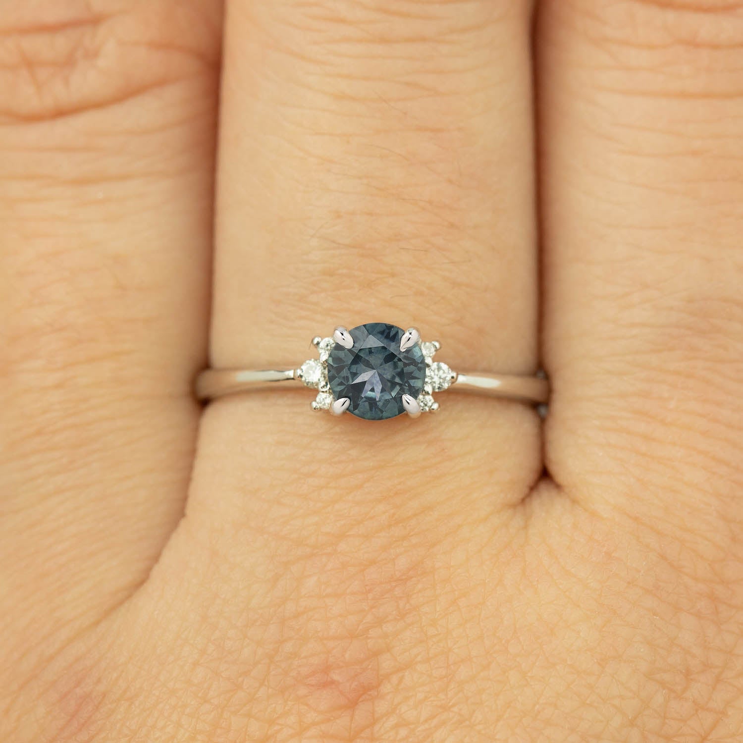 Stunning Lena Ring featuring a 0.65ct blue-green Montana Sapphire, set in 14k white gold with sparkling diamond accents.
