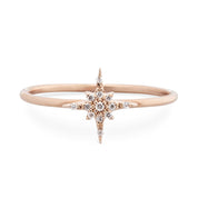 Rose gold starburst diamond ring with brilliant cut diamonds on a delicate 14k gold band