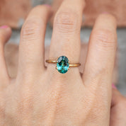 1.88ct oval cut green tourmaline ring set in gold on a hand with emerald green gemstone from Namibia