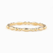 Close-up of Adina Ring, 1.5mm solid gold full eternity bead style band, ethically sourced and packaged in kraft box