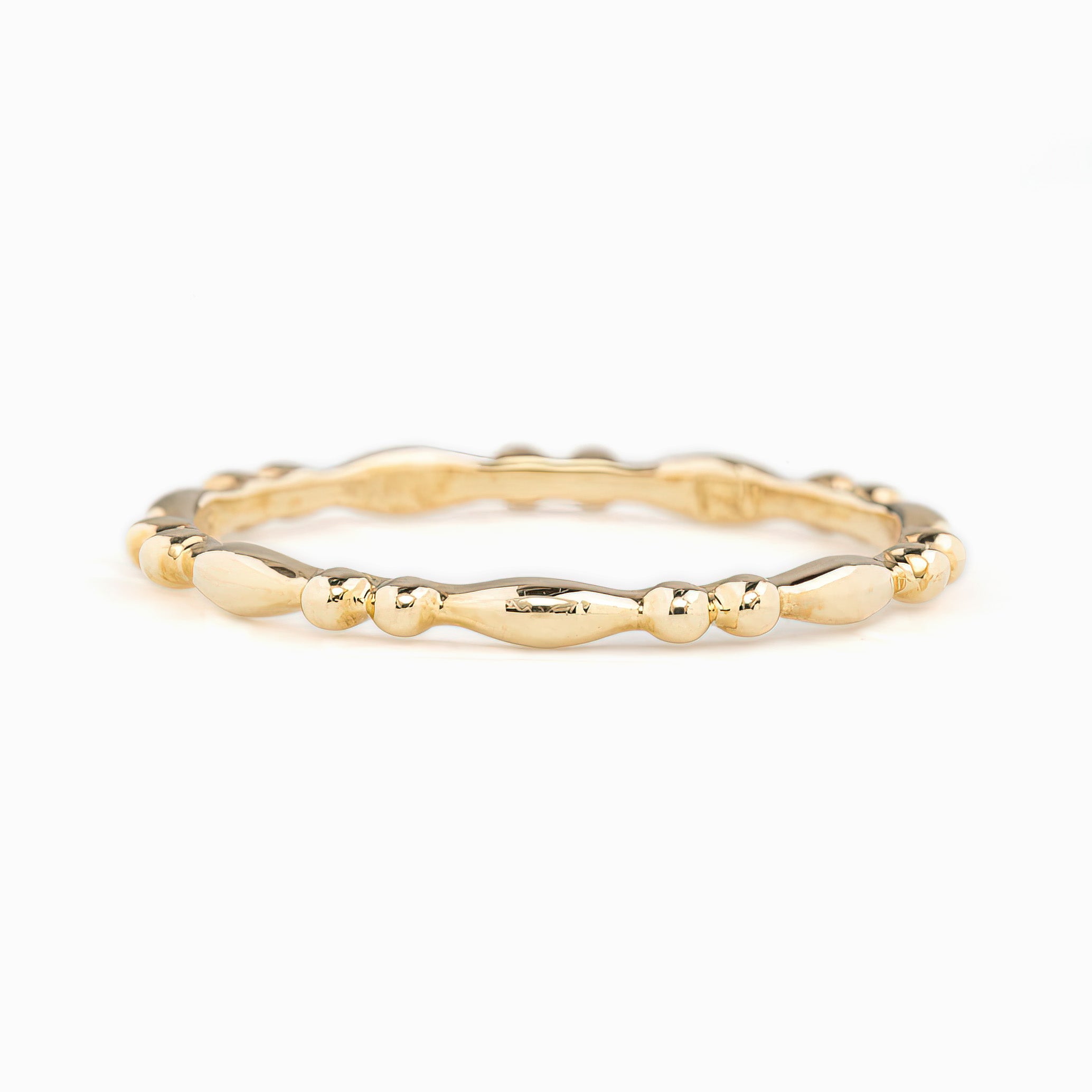 Close-up of Adina Ring, 1.5mm solid gold full eternity bead style band, ethically sourced and packaged in kraft box